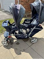 Front side view of double stroller showing front and rear seats and tray