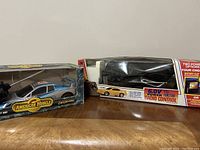 Two remote control cars in original packaging: American Muscle 1932 Ford Street Rod and 1:16 scale Ford Mustang
