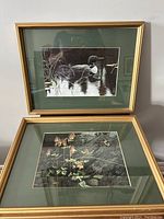 Two framed Robert Bateman prints stacked, one showing a loon on water