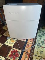 Front view of Blueair air purifier showing white body and ventilation grille.