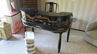 Front view of black lacquered Asian desk with curved hutch and gold hand-painted motifs