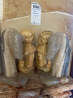 Front view of all four items: two stone horse bookends and two carved stone lion figurines, showing details and scale.