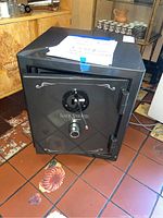 Front view of the Sanctuary Reserve safe showing the locked door with logo and decorative detail.