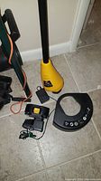 Toro cordless string trimmer parts including yellow bottom unit and charging adapter
