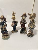 Four Boyd's Bears figurines together showing different characters and themed attire.