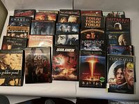 Photo of DVDs laid out on a surface showing front covers of various titles such as Erased, The Informant!, Night at the Museum.