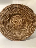 Top-down photo showing the entire circular woven basket with tight, consistent weaving and natural fiber materials.