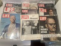 Photo showing seven Life magazine covers including John Serebrovsky with medals, Picasso, and Howard Hughes affair issue