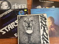 Photo showing six vinyl LP album covers including Santana, Jefferson Starship, The Moody Blues (two different albums), and Diana Ross.
