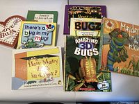 Front view of all 8 pop-up books stacked showing their colorful covers and titles related to bugs and insects.