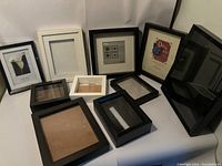 Overview of all approximate 10 shadow frames in black, white, and brown various sizes and shapes in a group