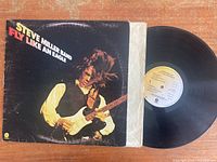 Image showing Steve Miller Band Fly Like An Eagle vinyl record and album cover with artist image and title.