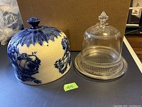 Both the ceramic and glass cheese cloches shown side by side on a flat surface for scale and comparison.
