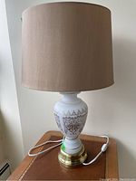 Full lamp with beige shade, showing overall height and style, cord with switch