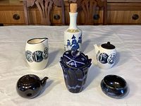 Front view of all six ceramic items on table showing design and arrangement.