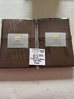 Two sealed sets of brown standard size pillowcases, each containing 2 pillowcases, from Distinctly Home with 400 thread count