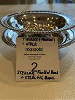 Two sterling silver bowls stacked to show profile of footed Birks bowl and beaded rims
