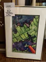 Framed abstract watercolor artwork with a white mat and grey frame, featuring a label from MaxSold and inscription.