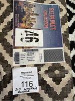 Close-up photo of tag showing brand and product details for black and white runner