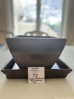 Front view of square ombré glazed heavy planter pot on matching tray with a lot tag in front