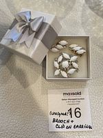 Brooch and earrings displayed inside a white gift box with silver ribbon bow, showing general set appearance and packaging.