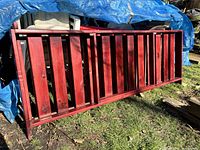 Photo of cherry wood double futon frame laid flat on ground, showing the slatted structure for mattress support.