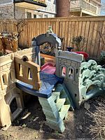 Photo showing the main structure including staircase, rock climbing walls, and covered platform.