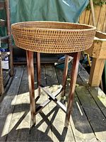 Full view of side table with rattan tray on the stand.