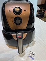 Front view of Secura air fryer showing timer and temperature control dials, and the fryer basket handle.