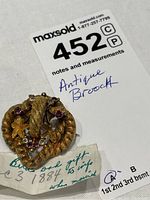Full view of brooch with lot tag