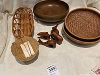 Photo of all items together including woven baskets, wooden bowl, wooden napkin holders, and woven coaster/trivet.