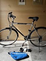 Full profile of silver and black Norco Yorkville bicycle with accessories