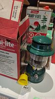 Photo of Coleman Easy Lite 2000 lantern with box and yellow funnel, front angle showing lantern and box details.