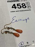 Full view of both earrings on white tag