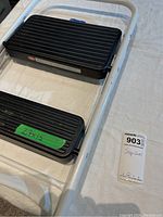 Stepstool folded showing the black ribbed steps and the label with dimensions 27 x 15.