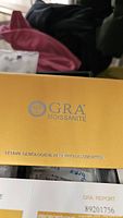 Yellow folder with GRA Moissanite logo showing the Global Gemological Research Association branding on certificate folder.