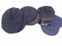 Four men's hats in black and navy blue shown from top view