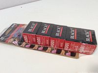 Pack of five Blacks brand 400 ISO photographic film rolls in original sealed packaging, showing film box fronts with exposure and ISO details.
