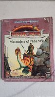 Front cover of Advanced Dungeons & Dragons Dark Sun Marauders of Nibenay RPG adventure module showing artwork of warrior on bird with wear and tear.