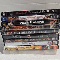 Photo showing stack of 10 DVD cases with titles visible.