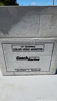 Box with "10" Diagonal Color Video Monitor" and "Coach Series" branding, showing part of box top and side.