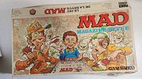 Photo of MAD Magazine themed board game box top with cartoon characters and MAD text.