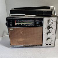 Front view of Rade Jefferson RDF Direction Finder radio showing frequency display, control knobs, speaker grille, and handle.