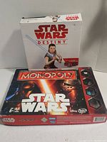 Two Star Wars-themed games stacked: Star Wars Destiny box on top and Star Wars Monopoly box below.