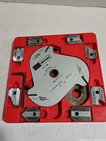 Front view of Craftsman molding head cutter set with blades in red plastic tray