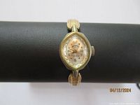 Front view of Andre Boucherd Duchess ladies watch showing the oval dial with gold hour markers and Arabic numerals at 12 and 6.