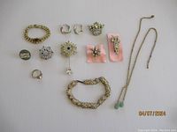 All items displayed on a flat surface showing full group of vintage rhinestone jewelry including bracelets, brooches, rings, earrings, and necklaces