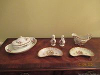 Wide view of all six pieces together showing the covered bowl, salt and pepper shakers, two bone dishes, and pitcher.