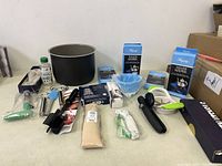 Overview of kitchen items: large cooking pot, many kitchen tools, and two boxes of Hagerty Silver Keeper silver polishing cloths