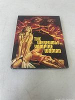 Front of sealed slipcase displaying the title and vintage artwork of werewolf and vampire woman.